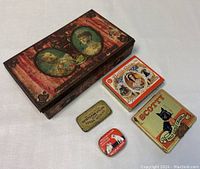 Top-down view of the five antique tins arranged together showing graphics and size comparison