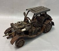 Metal Jeep model showing front left angle with detailed engine, exhaust, and front fender with wear and rust.