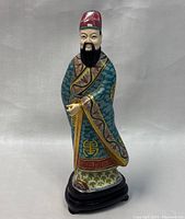 Front view of the vintage Chinese hand painted cloisonne man figurine showing detailed robe and facial features.