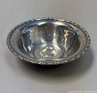 Top-down photo of the round sterling silver bowl showing polished interior and ornate rim.