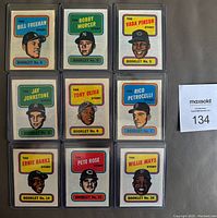 Front view of all 9 booklets individually sleeved, laid out in a 3x3 grid. Shows player portraits and booklet numbers.