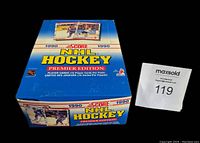 Blue 1990 Score NHL Hockey Premier Edition wax box with hockey player images, showing unopened state and label.