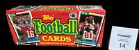 Closed factory box for 1990 Topps Football Card set showing front and side with prominent branding and player images