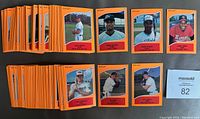 Full spread of many minor league baseball cards with orange borders laid out to display the variety included in the set.