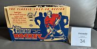 Closed exterior of the 2001-02 Topps Heritage Hockey empty wax box showing classic styled hockey player artwork and retro 1957-58 design branding.