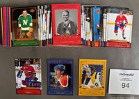 Stacks and spread of Upper Deck 2004-05 Legends Classics hockey trading cards showing various players and inserts including Hall of Fame Showcase cards with gold borders.