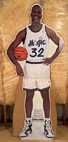 Full view of the life size cutout showing Shaquille O'Neal in full Orlando Magic uniform with basketball.
