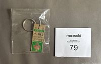 Keychain sealed in plastic bag showing front side with replica ticket dated MAR. 10, green and cream colors, and Maple Leaf hockey logo.