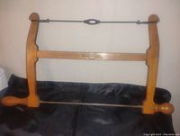 Full view of the wooden framed coping saw with blade and tensioning wire, showing the overall shape and condition.