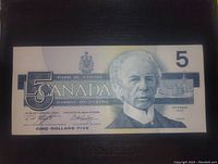 Front side of 1986 Canadian 5 dollar banknote showing Sir Wilfrid Laurier portrait and denomination details.