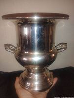 Front view of a large silver on brass Rogers Bros. champagne bucket showing the wide top rim, side handles, and rounded base.