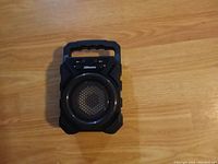 Top view of black 2Boom portable Bluetooth speaker showing circular speaker grill, control buttons and handle
