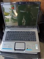 Photo of HP Pavilion dv6000 laptop open showing keyboard, screen, and touchpad