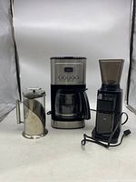 Full view of Cuisinart coffee maker, coffee grinder, and French press showing item sizes and conditions
