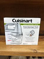 Front view of the Cuisinart hand mixer box showing product name, image, and key features.