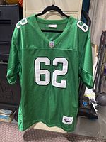 Front view of green Jason Kelce Philadelphia Eagles football jersey with white number 62 and NFL shield logo on neckline.