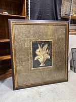 Full view of large framed floral art print with dark wooden frame and textured matting.