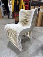 Front view of the chair showing the unique construction with white seat belt material tightly stretched and layered.