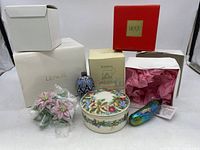 Image showing all four items: Lenox poinsettia flowers, Mikasa bowl, enamel ornament, and glass pickle ornament with boxes in background.