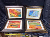 Four framed mixed media collage artworks by Stephen Millner displayed together, showing a variety of colors and textures.