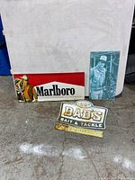 View of all three vintage advertising signs Marlboro, John Wayne, Dad's Bait & Tackle.