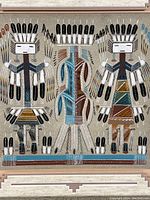 Close-up view of central portion of sand painting showing three stylized figures and multicolor sand detail