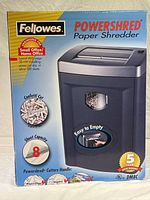 Front of the Fellowes Powershred DM8C paper shredder box showing confetti cut, 8 sheet capacity, and 5-year warranty.