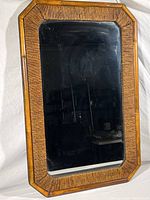 Full view of the rectangular framed mirror with bamboo-style wicker wrapped frame.