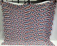 Front view of red, white, and blue handmade knitted blanket approximately 53 x 53 inches with wave-like stitch pattern.
