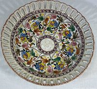 Top-down view showing detailed hand-painted floral and fruit design with vibrant colors and glazed finish.