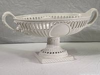 Full view of the large white ceramic pedestal fruit bowl comport showing the lattice design, handles and pedestal base.