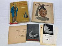 Overview of two hardcover books and multiple silk-related pamphlets and papers
