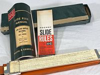 Photo of slide rule, manuals, and carrying case laid out showing all included items.