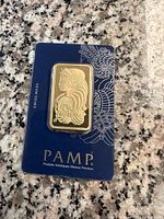 Front of PAMP Suisse gold bar in blue assay packaging showing Lady Fortuna design