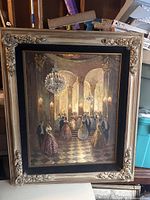 Full view of oil painting in ornate carved frame showing ballroom scene with chandeliers and elegant guests