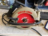 Close-up of a 7 1/4 inch Porter Cable circular saw with a red ABTO blade on a workbench.