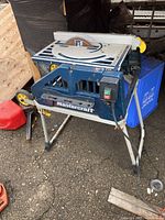 Mastercraft table saw showing the full saw on its foldable metal stand with blade and power switch.