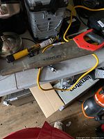 Husky handsaw with red and black handle resting on a surface, showing blade wear.