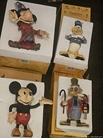 Lot of 4 Disney figurines in original boxes with white foam protection: Sorcerer Mickey Mouse, Donald Duck, Mickey Mouse, Scrooge McDuck.