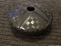 Top view showing the geometric and checkered pattern on the surface of the black pottery.