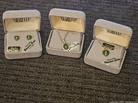 Photo showing three jewelry items: earrings, necklace, and bracelet, each in a box labeled 'Alaska's Finest Quality'.