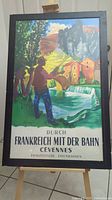 Full view of framed vintage French railways German advertisement poster featuring colorful Cévennes landscape with fisher.
