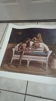 Full view of the vintage signed Robert Olson print showing two girls seated on a wicker bench with one playing flute