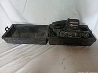 Craftsman belt sander and open black carrying case showing the sander inside.