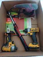 Overview of the four tools in the box: electric sander, digital torque wrench, and two Dewalt cordless drills.