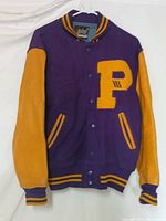 Front view of purple and yellow Whiting High School letterman jacket with large 'P' patch on chest and leather sleeves.