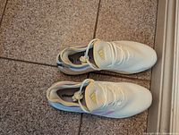 Top view of the Adidas Cloudfoam women's shoes showing the white mesh upper and pastel accents.