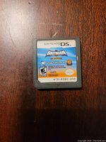 Front view of Batman the Brave and the Bold Nintendo DS game cartridge showing label and logos.
