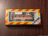 Lionel Southern Pacific Caboose model in original box showing front and side with box design.