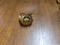 Front view of the gold-tone Boston Bruins 1929 Stanley Cup ring showing the team name and stone.